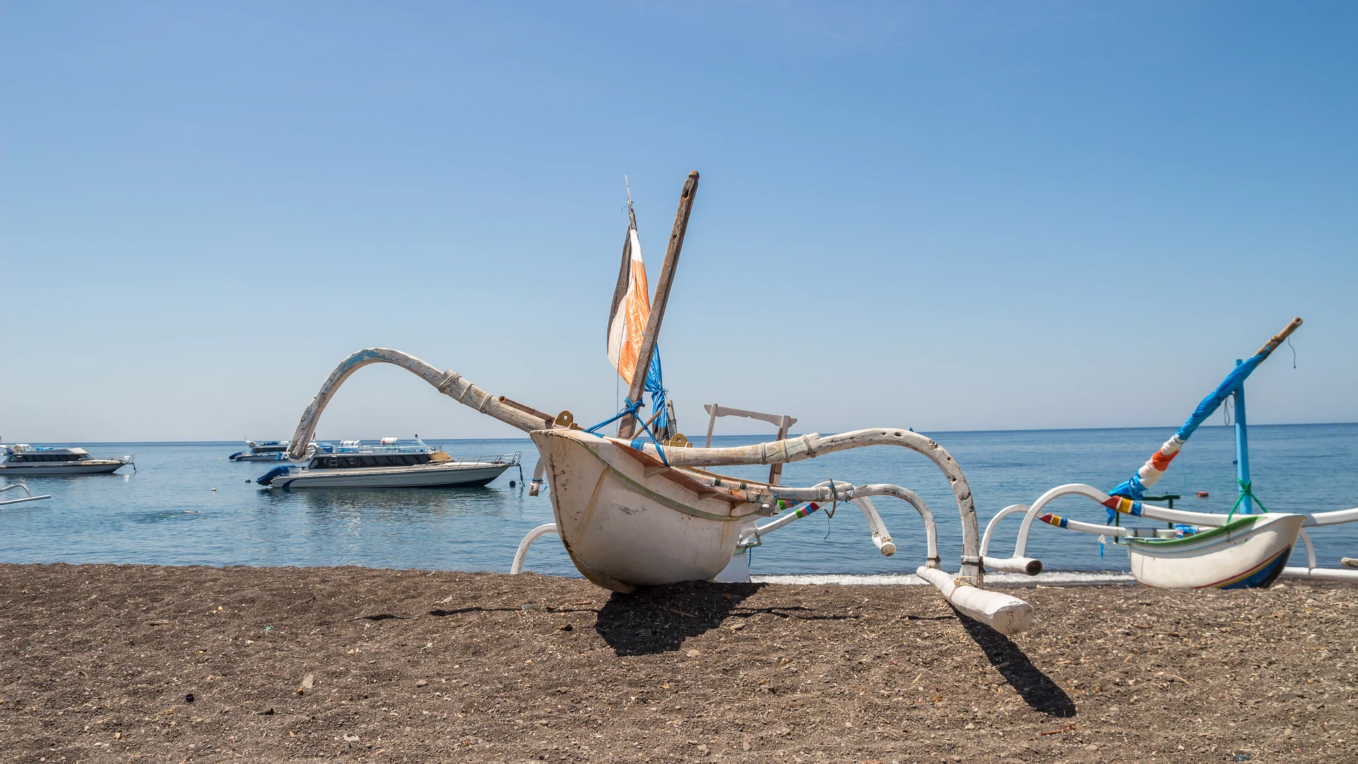 Traditional jukung fishing boats on Amed's black-sand beach, Bali