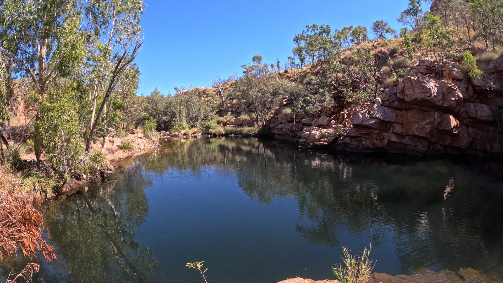 Red-cliff river gorge with reflections