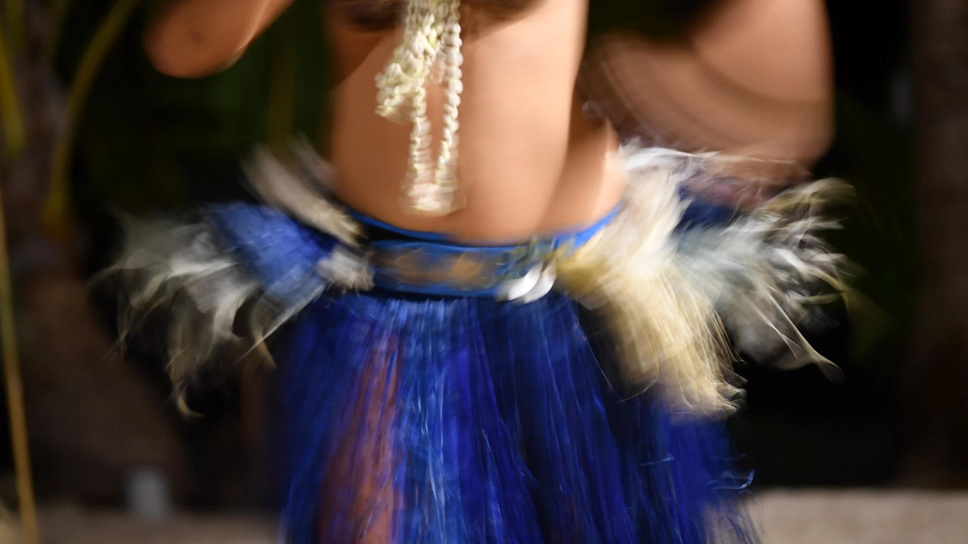 Polynesian dancer performing in traditional costume