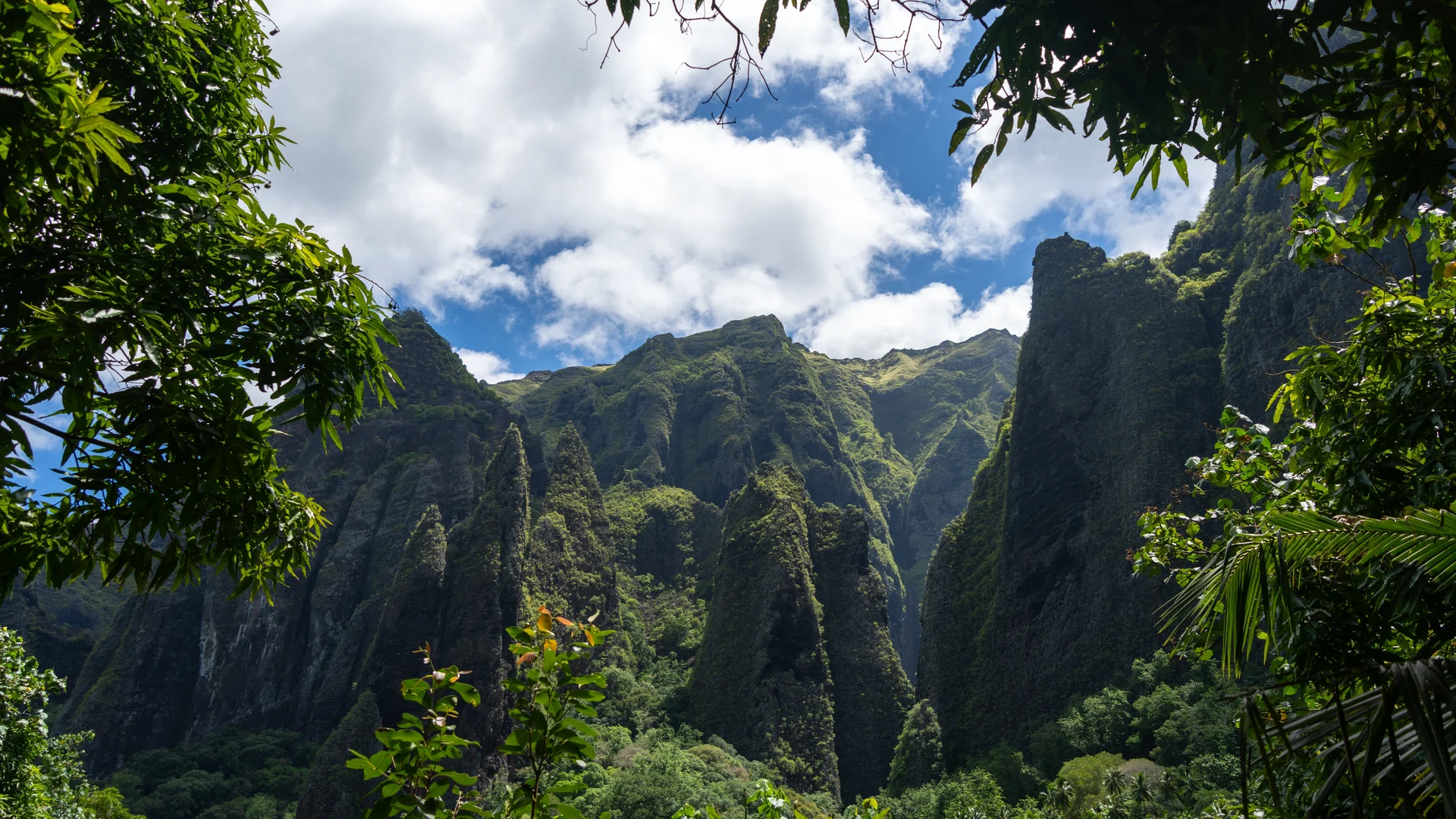 Towering emerald volcanic cliffs in a valley on Nuku Hiva