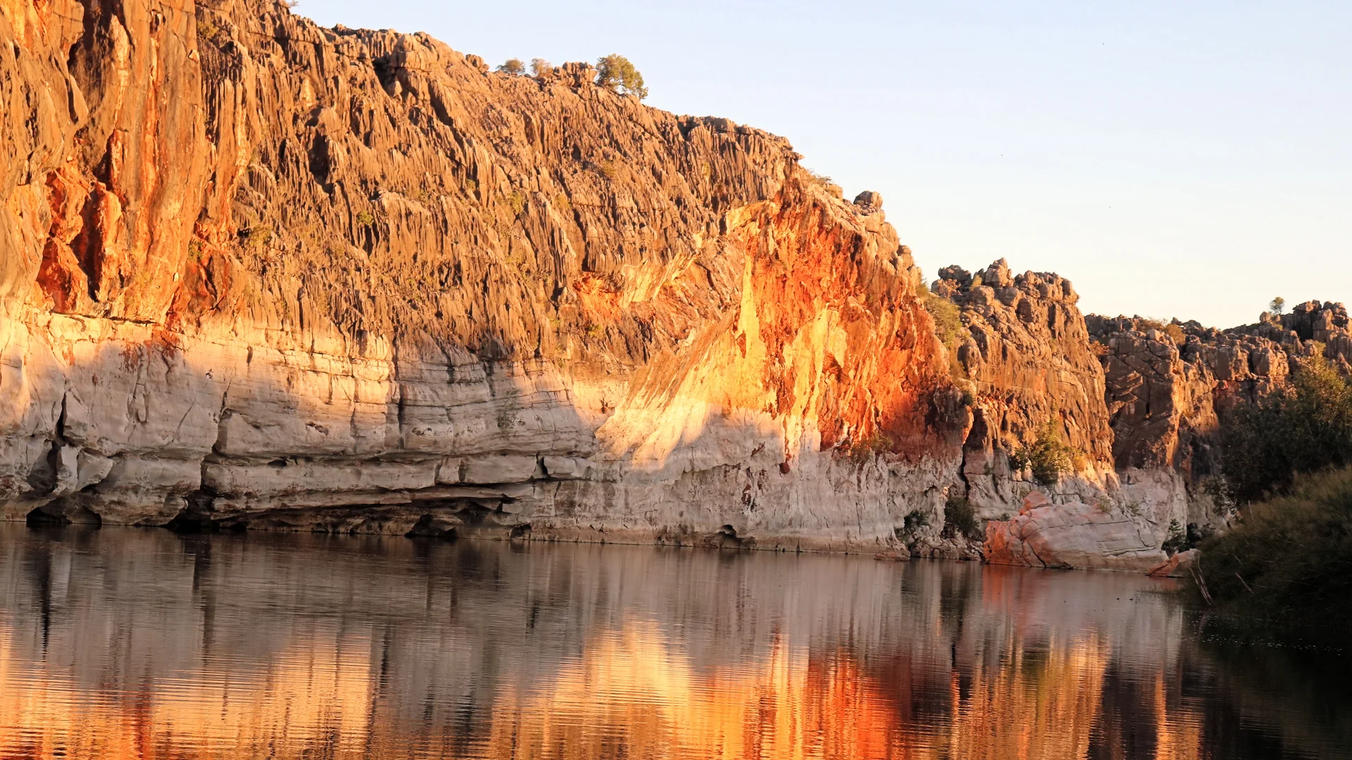 Golden-lit red Kimberley gorge with river