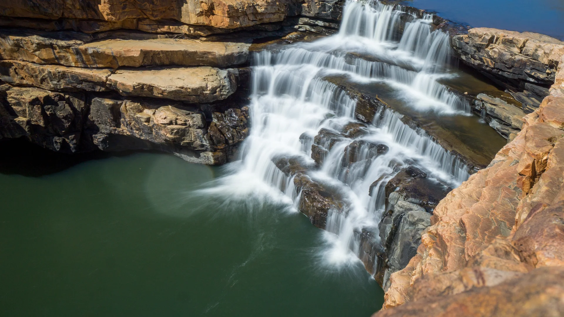 Bell Gorge waterfall cascading into a pool
