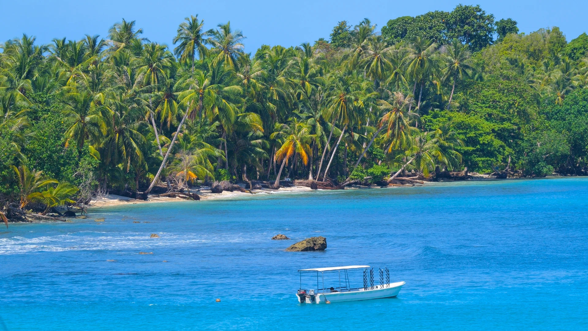 Small boat on clear turquoise water, West Papua