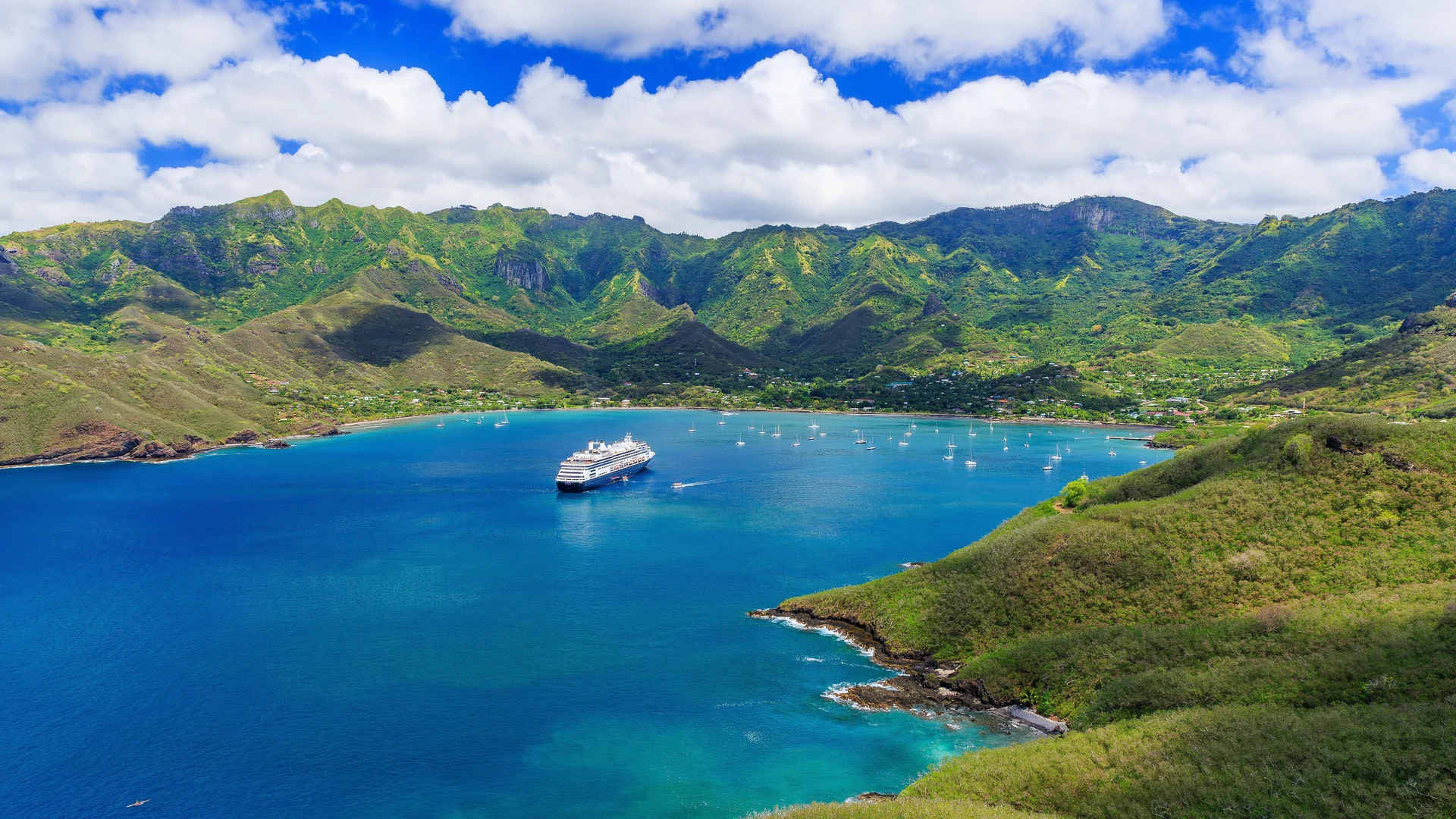 Turquoise bay ringed by green hills at Nuku Hiva in the Marquesas