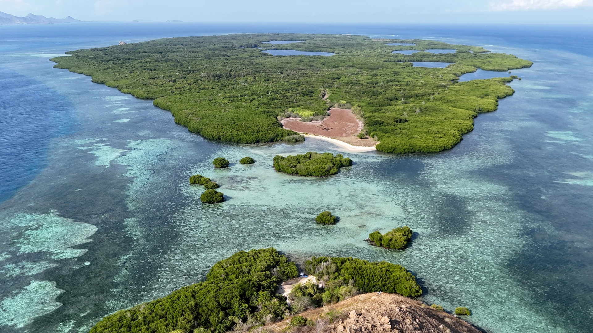 Coral-rimmed tropical island from the air, Cenderawasih Bay