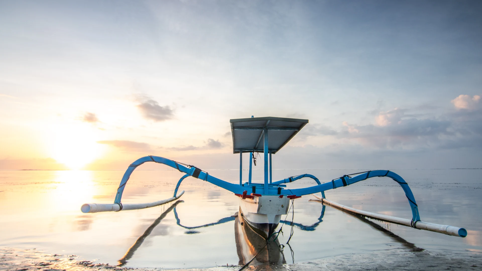 Traditional jukung outrigger at sunrise, Sanur beach, Bali