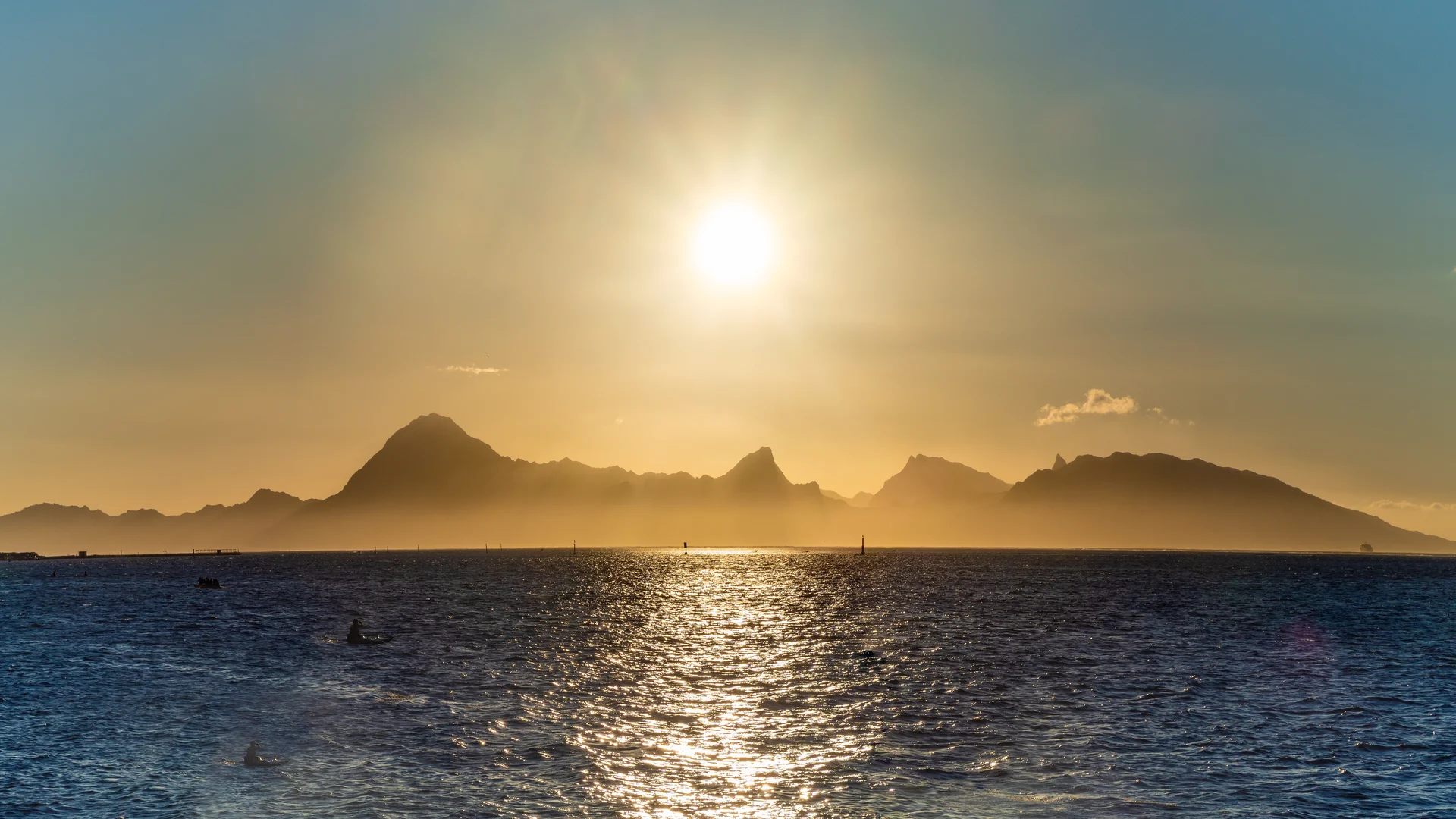 Golden sunset over the sea with the silhouette of Moorea
