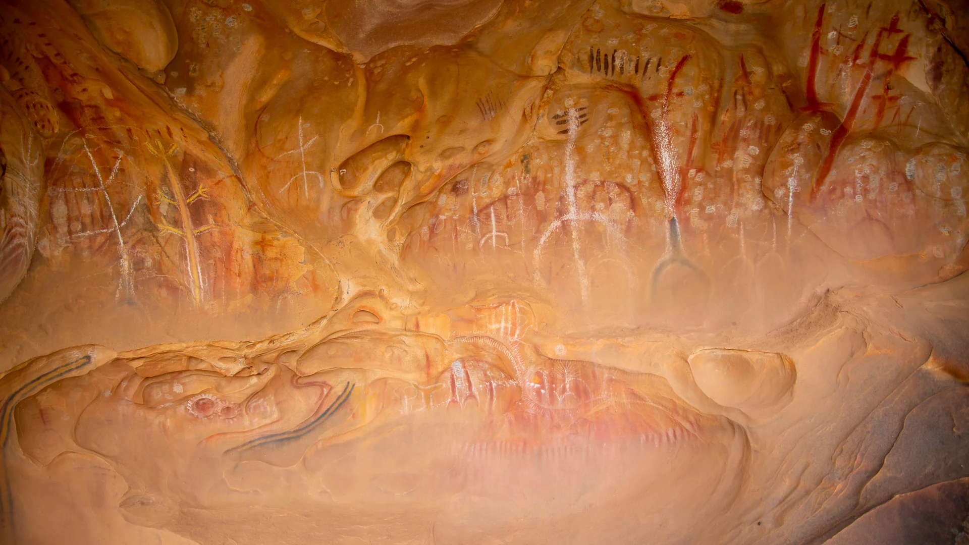 Aboriginal rock art, red hand stencils and ochre figures